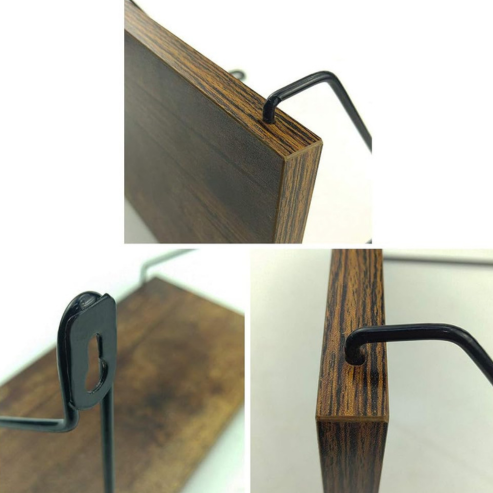 Gros plans sur la planche et les supports métalliques noirs de l’étagère murale.